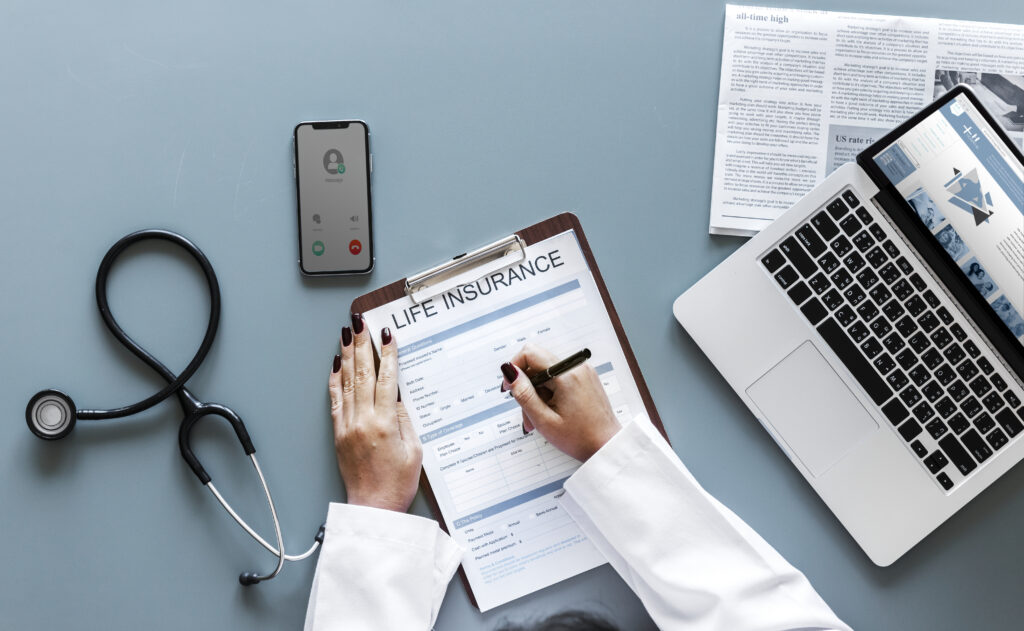 doctor-filling-up-life-insurance-form